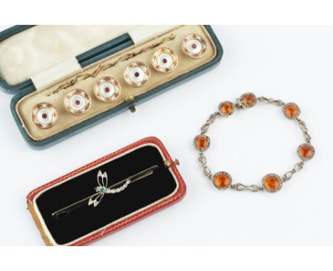 A COLLECTION OF JEWELLERY, comprising a diamond and gem set dragonfly bar brooch, an orange and white stone bracelet, with al