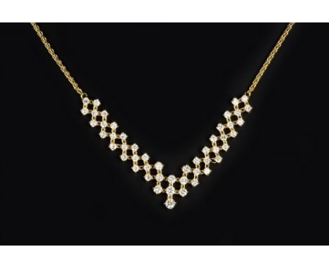 A DIAMOND PENDANT NECKLACE, designed as an articulated lattice of round brilliant-cut diamonds in claw settings, suspending a