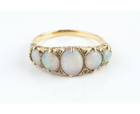 AN OPAL FIVE STONE RING, the oval and circular cabochon opals spaced by rose-cut diamonds points, above a scrolled gallery, y