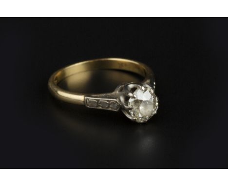 A DIAMOND SINGLE STONE RING, the cushion-shaped old-cut diamond in eight claw setting, between engraved shoulders, two colour