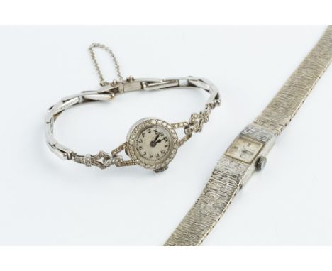 A LADY'S DIAMOND SET COCKTAIL WATCH, the circular silvered dial with Arabic numerals, to a manual wind movement and case stam