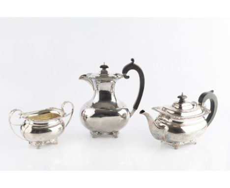 A SILVER THREE PIECE TEA SERVICE, with gadrooned and foliate cast borders, on scroll and paw feet, comprising teapot, hot wat