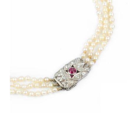 A CULTURED PEARL TRIPLE STRAND NECKLACE WITH RUBY AND DIAMOND SET CLASP, comprising three strands of graduated cultured pearl