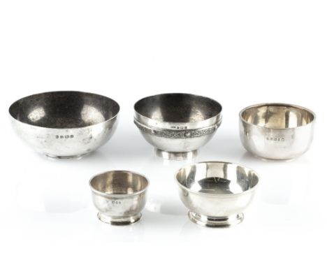 A SILVER SUGAR BASIN with a raised band of Celtic style decoration, by Duncan & Scobbie, Birmingham 1935, 10cm wide; and four