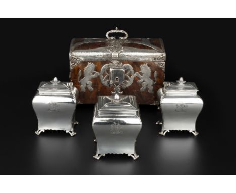 A SET OF THREE GEORGE III SILVER TEA CADDIES of rectangular bombe form, the covers with pinecone finials, on pierced and shap