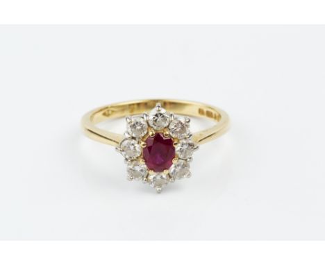 A RUBY AND DIAMOND CLUSTER RING, the oval mixed-cut ruby claw set within a border of round brilliant-cut diamonds, 18ct gold 