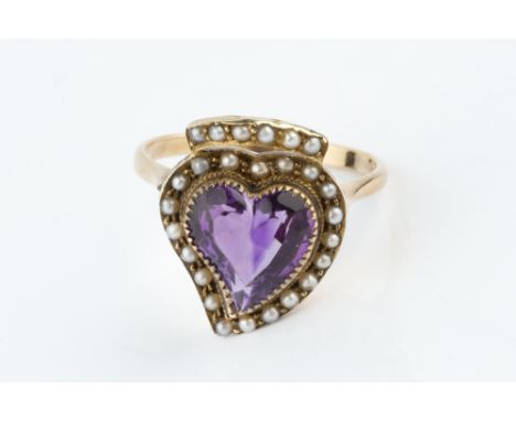 AN AMETHYST AND HALF PEARL PANEL RING, centred with a heart-shaped mixed-cut amethyst, within a half pearl border and surmoun