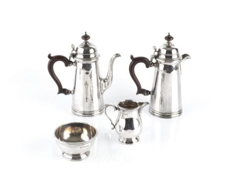 A SILVER FOUR PIECE BACHELOR'S COFFEE SERVICE, comprising coffee pot and hot water pot, with domed covers, and composite hand