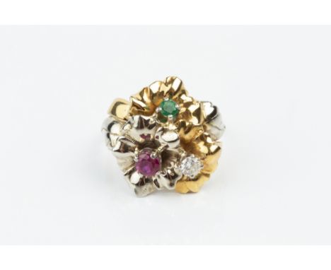 A VARI GEM-SET DRESS RING, modelled as three entwined flowerheads, individually centred with a round brilliant-cut diamond, a