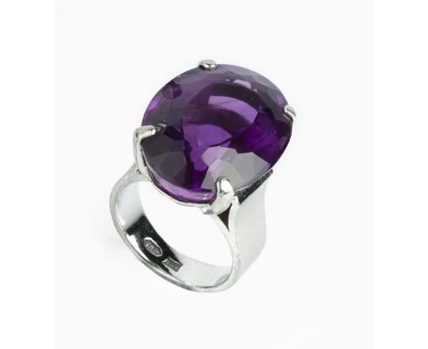 AN AMETHYST SINGLE STONE RING, the oval mixed-cut amethyst in four claw setting, white precious metal mounted, stamped '14k',