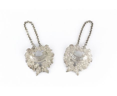 A PAIR OF GEORGE III SILVER LARGE DECANTER LABELS, for Port and Sherry, each cast as a wreath of fruiting vine with a sash be