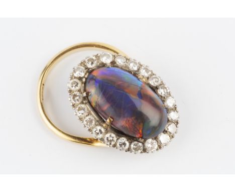 A BLACK OPAL AND DIAMOND CLUSTER RING, the oval cabochon black opal measuring approximately 16.2mm length x 9.2mm width x 3.7