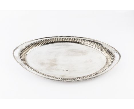 A LATE VICTORIAN SILVER OVAL TWIN HANDLED TEA TRAY, with reeded edge and gadrooned border, by Harrison Brothers & Howson, She