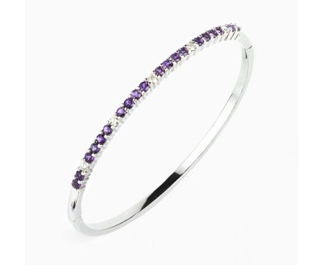 AN AMETHYST AND DIAMOND LINE BANGLE, the oval hinged bangle claw set with a line of circular mixed-cut amethysts, spaced by f