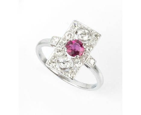 A PINK TOURMALINE AND DIAMOND PANEL RING, the rectangular pierced and millegrain panel centred with a circular mixed-cut pink