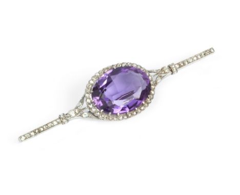 AN AMETHYST AND DIAMOND CLUSTER BAR BROOCH, centred with an oval mixed-cut amethyst bordered by millegrain set rose-cut diamo