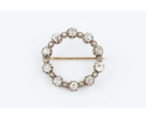 A DIAMOND CIRCLET BROOCH, designed as a row of cushion-shaped old-cut diamonds in pinched collet settings, spaced by similarl