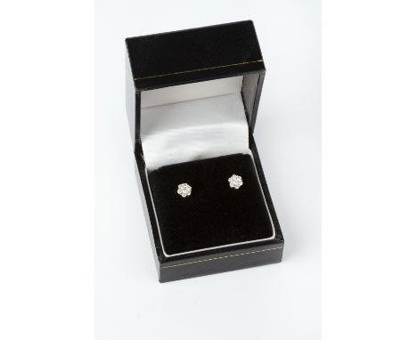 A PAIR OF DIAMOND CLUSTER EAR STUDS, each designed as a flowerhead cluster of round brilliant-cut diamonds in claw setting, o