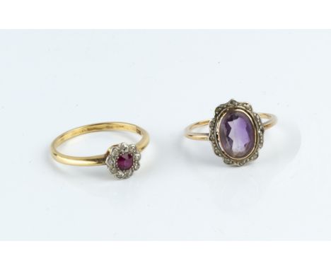 A RUBY AND DIAMOND CLUSTER RING, the circular mixed-cut ruby bordered by single-cut diamonds, two colour precious metal mount
