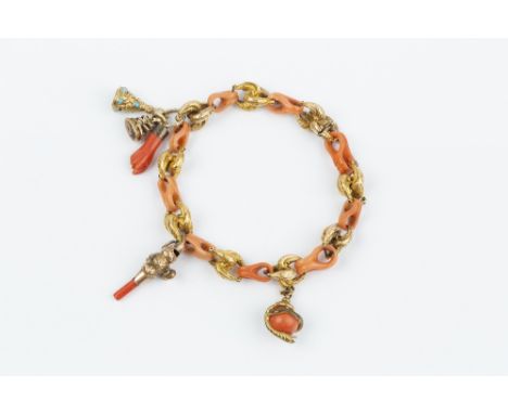 A 19TH CENTURY CORAL FANCY-LINK BRACELET, designed as a line of carved coral corallium rubrum panels, spaced by foliate scrol