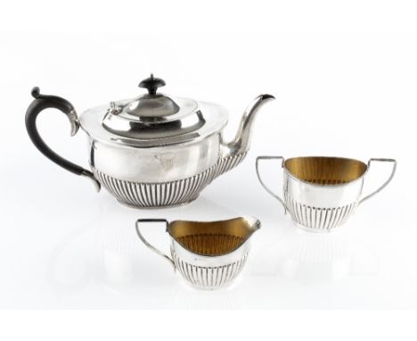 AN EDWARDIAN SILVER TEAPOT, of oval half-lobed design, with ebonised handle and knop, by James Deakin &amp; Sons, Sheffield 1