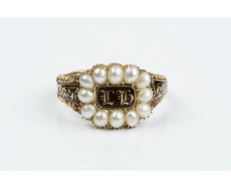 A GEORGIAN HALF PEARL AND ENAMEL MEMORIAL RING, centred with a black enamel panel inscribed 'LH', bordered by half pearls, be
