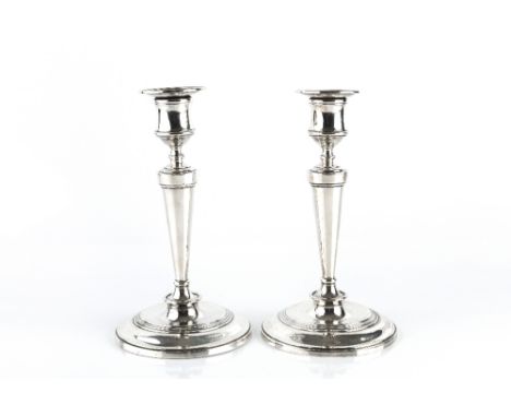 A PAIR OF EDWARDIAN SILVER CANDLESTICKS, with tapered, knopped stems on weighted circular bases, by William Hutton & Sons Ltd