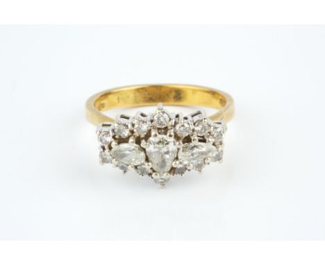 A DIAMOND CLUSTER RING, centred with a trio of pear-shaped brilliant-cut diamonds in claw settings, bordered by a row of simi
