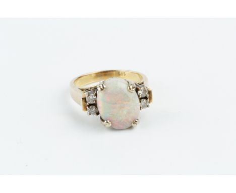 AN OPAL AND DIAMOND RING, the oval cabochon opal claw set between pairs of round brilliant-cut diamonds, two colour precious 