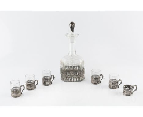 A CONTINENTAL EARLY 20TH CENTURY SILVER MOUNTED GLASS LIQUEUR DECANTER, with six matching glass holders, the mounts pierced a