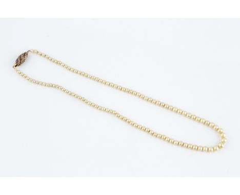 A SIMULATED PEARL NECKLACE WITH RUBY AND DIAMOND SET CLASP, the single strand of simulated pearls to a barrel-shaped clasp, s