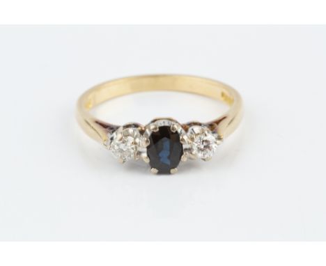 A SAPPHIRE AND DIAMOND THREE STONE RING, the oval mixed-cut sapphire claw set between two round brilliant-cut diamonds, 18ct 