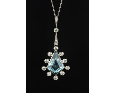 AN ART DECO AQUAMARINE AND DIAMOND PENDANT, the kite-shaped step-cut aquamarine drop in collet setting, bordered by similarly