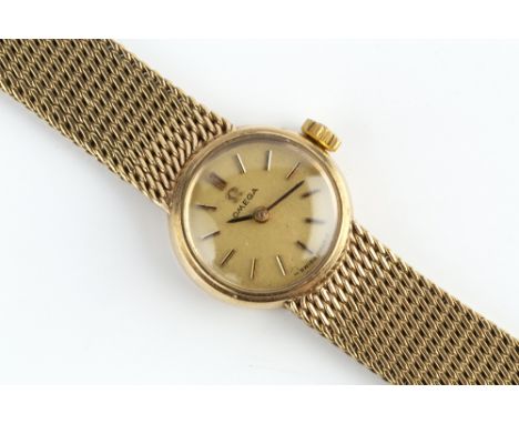 A LADY'S 9CT GOLD BRACELET WATCH BY OMEGA, the circular dial with baton markers, to a jewelled manual wind movement numbered 