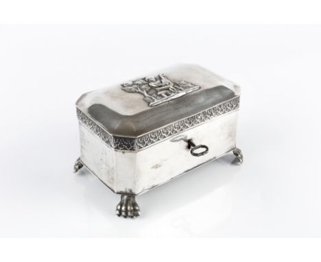 A 19TH CENTURY GERMAN SILVER CASKET, of canted rectangular form, the lid applied with a cherub playing a lute, on paw feet, B