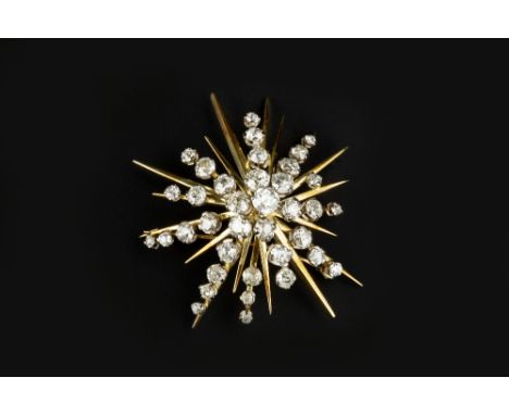 A DIAMOND STAR BROOCH, of abstract design, the tiered cluster of graduated old and single-cut diamonds in claw settings, two 