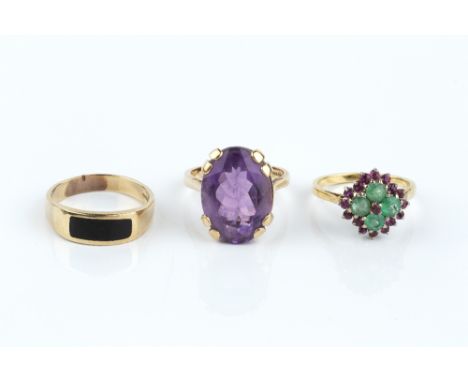 THREE DRESS RINGS, comprising an emerald and ruby cluster ring, stamped '18ct', an amethyst single stone ring, 9ct gold mount