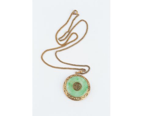 A JADE ANNULAR PENDANT ON CHAIN, the circular jadeite panel centred with an oriental character motif, within a pierced foliat