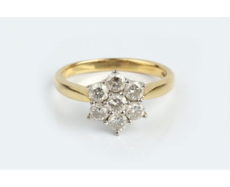 A DIAMOND CLUSTER RING, designed as a flowerhead cluster of round brilliant-cut diamonds, in claw setting, 18ct two colour go