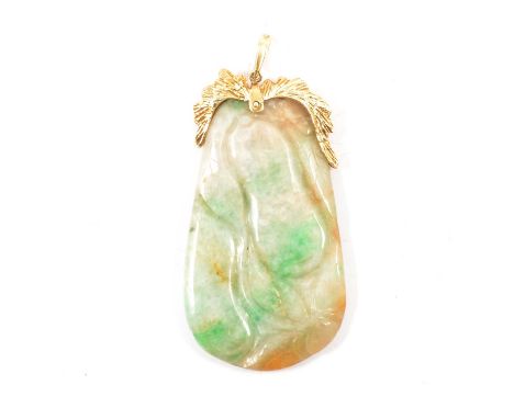 A variable coloured jade pendant with 18K mount, the carved jade tab 50x28mm having a barked textured mount to top marked 18K