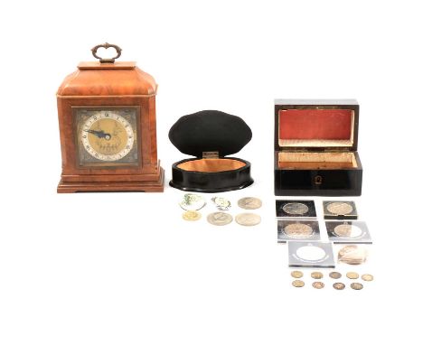 An Elliott walnut mantle clock, ebony box, another wooden box and commemorative crowns.