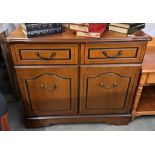 A mahogany effect two door cabinet. COLLECT ONLY.