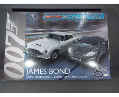 Retail Stock - a Micro Scalextric Jmes Bond Aston Martind DB5 and Aston Martin DBS action set, box has a few creases.