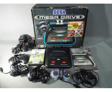 Sega - A boxed Sega Mega Drive II games console with six controllers, instructions and boxed World Class Leaderboard game car