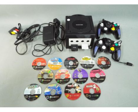 Nintendo - A Nintendo GameCube console with two controllers, memory cards and thirteen game discs (unboxed) to include Metroi