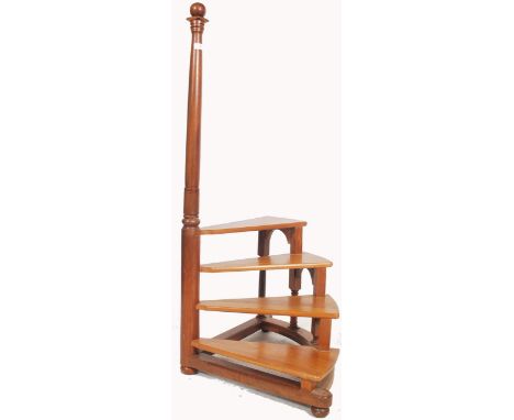 A good set of 20th century mahogany library steps. The steps of spiral form culminating in a turned hand column with finial t