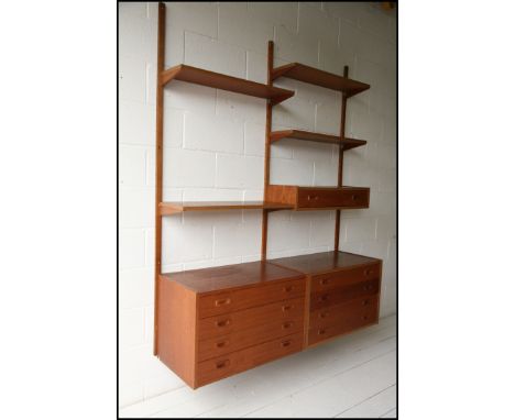 A 1960's mid century teak veneer set of &lsquo;PS System&rsquo; shelves and cabinets. Made in Denmark. Consisting of 2 chests