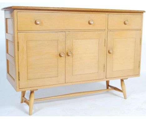 A mid century 1950s light Ercol Sideboard&nbsp; with elm plank top above beech front with drawers over cupboards, raised on s