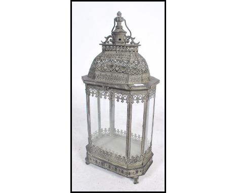 An unusual 20th century large aged metal Indian porch lantern for candles. Intricate pierced frame with details having large 
