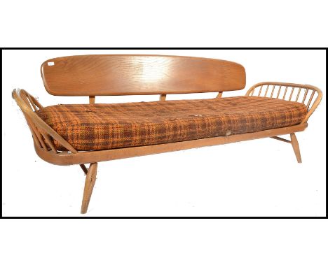 An original Ercol 1970's day bed sofa settee complete with the original cushion. Light beech and elm construction stood on ta